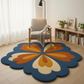 Floral-patterned rug on a wooden floor with a chair and bookshelf in the background.