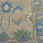 Close-up of a patterned fabric with floral and geometric designs.