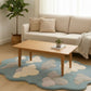 Living room with a beige sofa, wooden coffee table, and cloud-patterned rug.