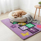 Dog lying on a colorful rug with numbers and shapes in a bright room.