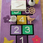 Children's play area with a colorful rug featuring numbers and letters.