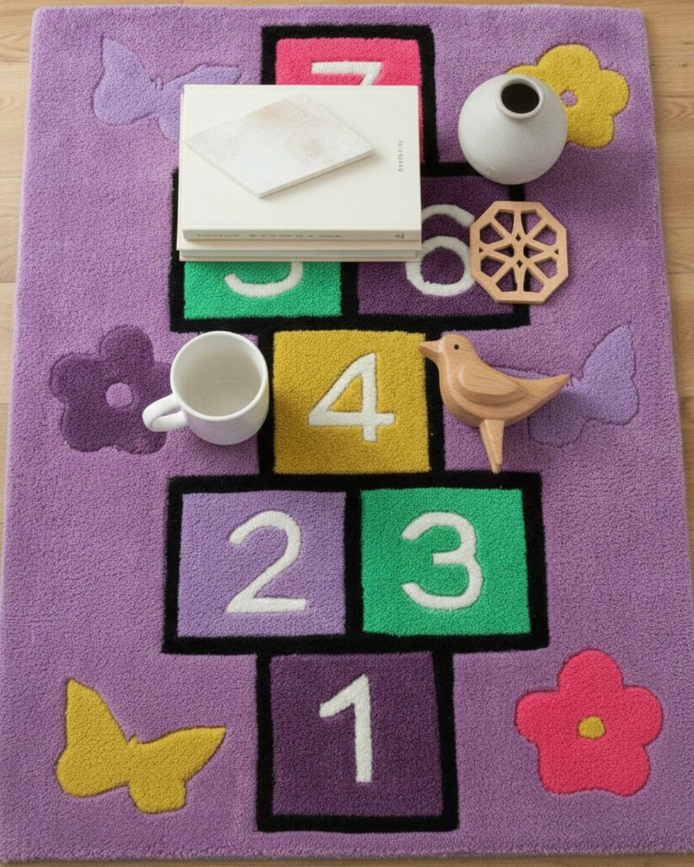 Children's play area with a colorful rug featuring numbers and letters.