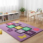 Children's playroom with a colorful rug featuring numbers and shapes on a wooden floor.
