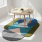 Colorful geometric rug on a white floor with a wooden table and chairs.
