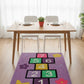 Dining room with a colorful hopscotch rug on the floor.