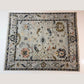 Decorative rug with intricate patterns on a plain background