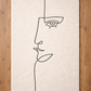 Abstract line drawing of a face on textured paper with wooden borders