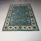 Decorative blue and beige rug on a white floor
