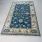 Decorative rug with intricate patterns on a white floor