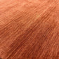 A close-up of a textured material swatch with a warm coppery-brown color and fine ribbed striations.