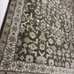 Close-up of a patterned rug with geometric and floral designs.