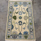Decorative rug with floral patterns on a concrete floor