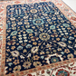 Decorative rug with intricate floral patterns on a blue background
