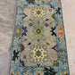 Decorative rug with floral and geometric patterns on a neutral background