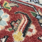 Close-up of a textured rug with intricate patterns and vibrant colors.