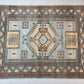 Decorative rug with geometric pattern on a white floor