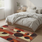 Bedroom with a colorful geometric rug on the floor