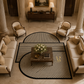 A luxury living room featuring a modern geometric area rug with black and beige striped semi-circles and rectangles, styled with cream sofas, armchairs, and a marble coffee table.