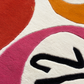 Close-up of a textured surface with circular patterns in red, orange, and pink.