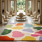 Colorful abstract rug in a grand room with columns and chairs.