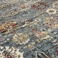 Close-up of a patterned rug with blue, red, and beige colors.