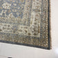 Corner of a patterned rug on a light-colored floor