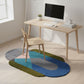Modern office setup with a wooden desk, chair, and colorful rug on a light wood floor.