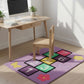 Children's play area with a colorful hopscotch rug, wooden desk, and chair.