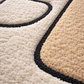 Close-up of a textured rug with geometric pattern