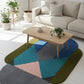 Geometric patterned rug on a white floor with a beige sofa and coffee table in the background.
