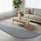 Living room with a sectional sofa, coffee table, and colorful rug.