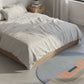 Bedroom with a bed, nightstand, and colorful rug.