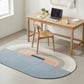 Modern home office with a wooden desk, chair, and colorful rug.