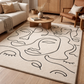 Living room with a decorative rug featuring abstract face designs.
