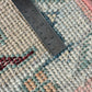 Close-up of a textured rug with a ruler for scale