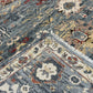 Close-up of a patterned rug with intricate designs and colors.