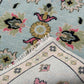 Close-up of a patterned rug with floral designs on a light blue background.