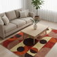 Living room with a beige sofa, wooden coffee table, and a colorful geometric rug.