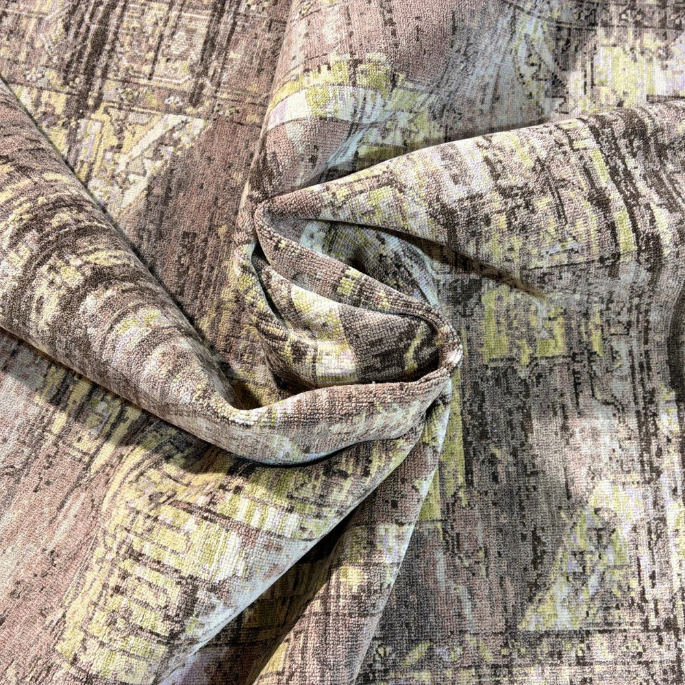 Close-up of textured fabric with a pattern of brown, yellow, and gray.
