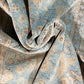 Close-up of textured fabric with a pattern in shades of blue and brown.