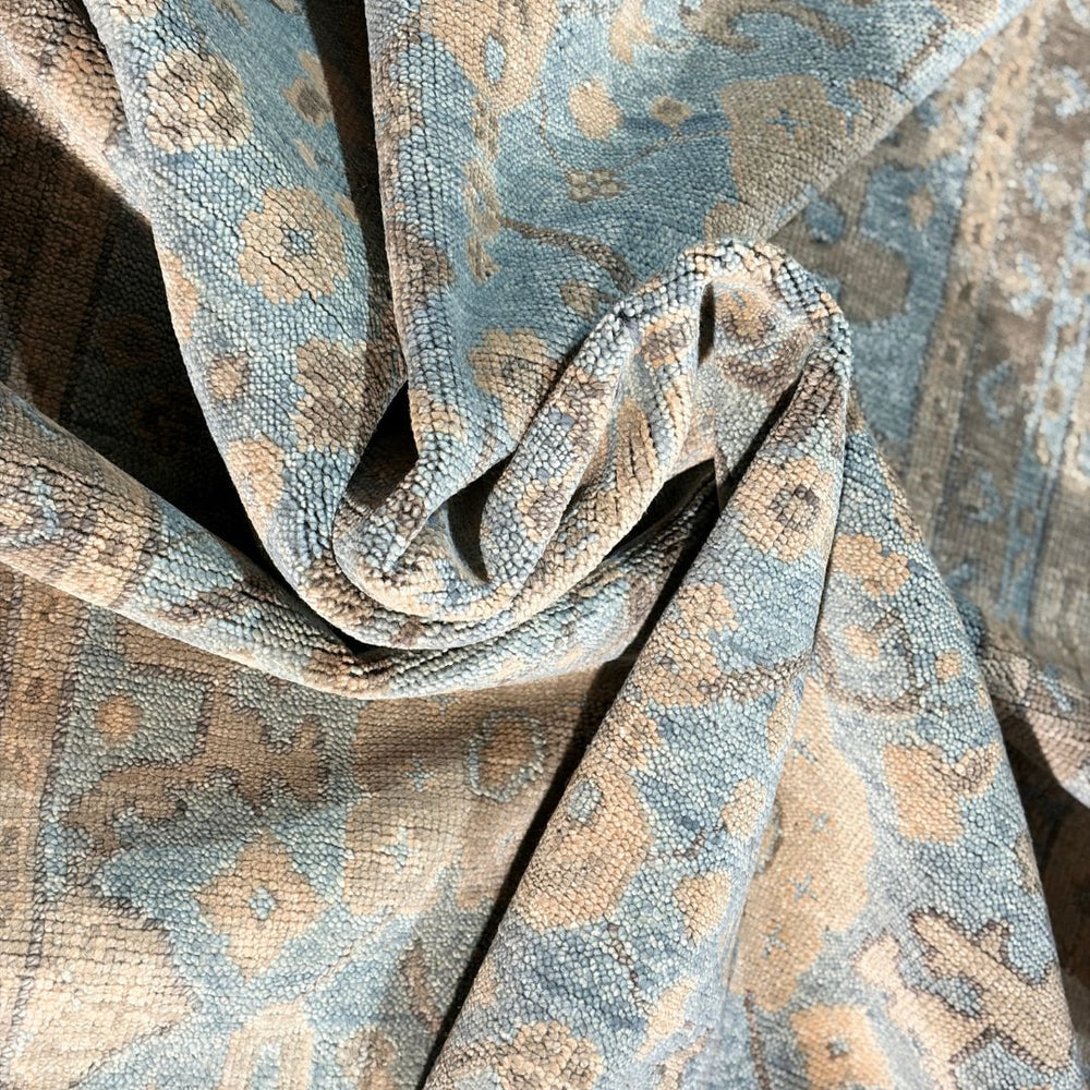 Close-up of textured fabric with a pattern in shades of blue and brown.