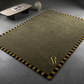 Green rug with gold border and logo on a gray floor