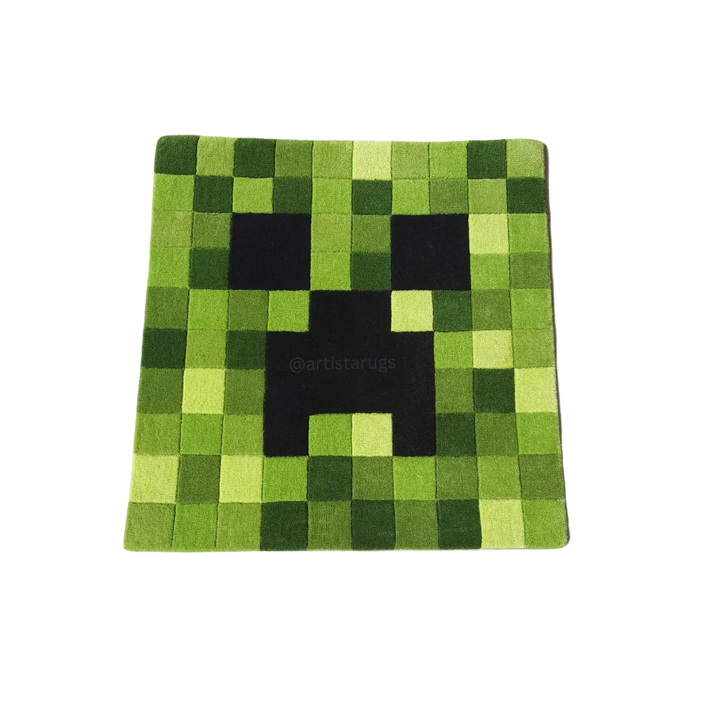 Green pixelated rug with a black face design on a white background