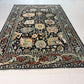 Decorative rug with intricate patterns on a white floor