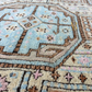 Close-up of a patterned rug with intricate designs and colors.