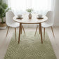 Dining room with a round table, chairs, and a green patterned rug.