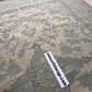 Patterned rug with a visible brand label on a neutral background