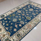 Decorative rug with floral patterns on a tiled floor