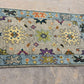 Decorative rug with floral patterns on a concrete floor