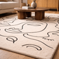 Beige rug with black abstract designs in a living room setting